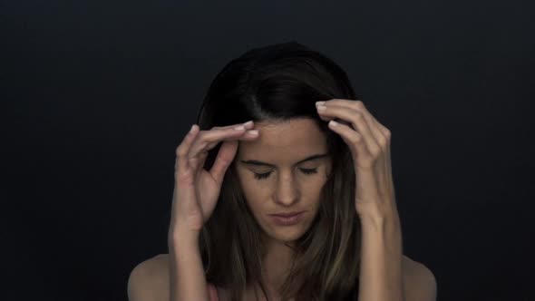 Woman pushing hair behind ears, slow motion