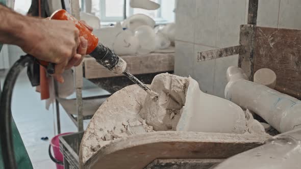 Man Removing Plaster Cast From Socket