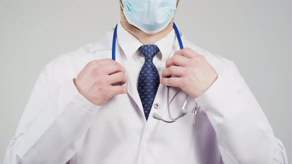 Doctor putting stethoscope around his neck