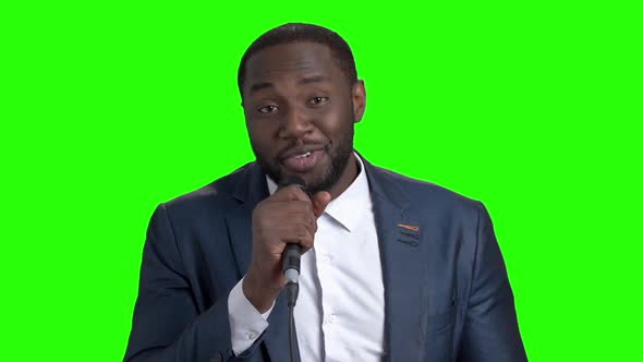 Smiling Man with Microphone on Green Screen