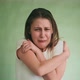 Scared Crying Woman in White Tshirt Hugs Herself on Green - VideoHive Item for Sale
