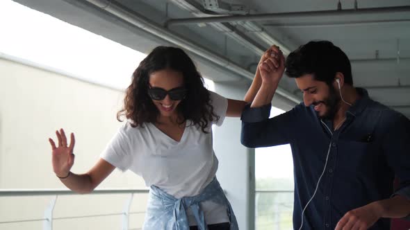 Happy Couple Having Fun And Skateboarding At Parking Lot