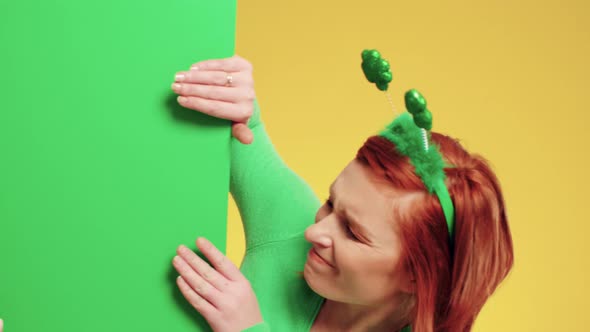 Smiling woman with green banner in studio shot