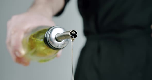 Chef Pouring Olive Oil. Close Up Slow Motion