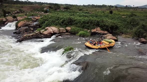 Yellow rafting boat rafting down the Nile River waterfalls, Jinja, Uganda. Drone view 4k