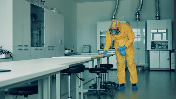 Sanitation Worker Is Cleaning Table Surface in the Quantorium