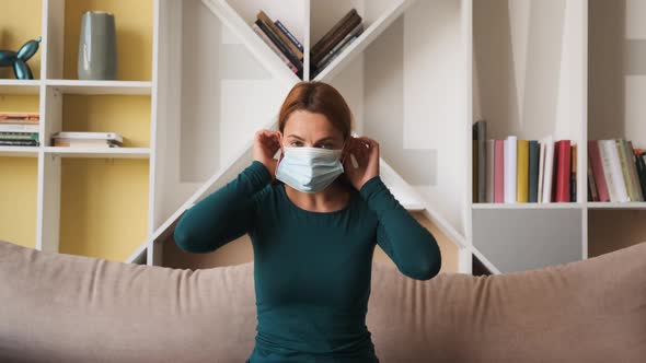 Portrait of a Young Woman Wearing Protective Mask at Home. Concept of Health and Safety