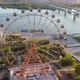 Drone View Colorful Ferris Wheel in Amusement Park on River and City Landscape - VideoHive Item for Sale