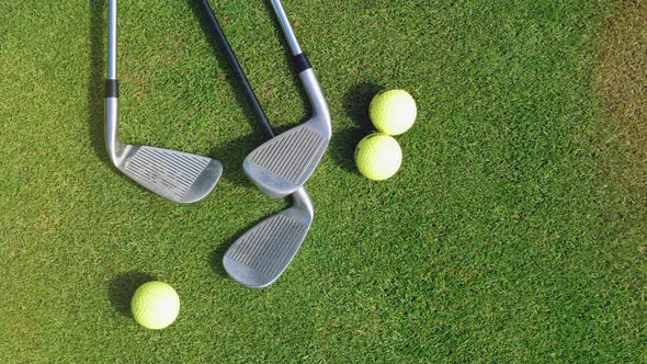 Golf Clubs and Ball on a Green Grass