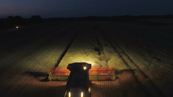 Night Time Harvest Using a Large Combine Harvester in a Field