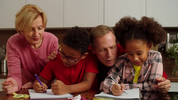 Multiiethnic Multigenerational Family with School Children Studying at Home