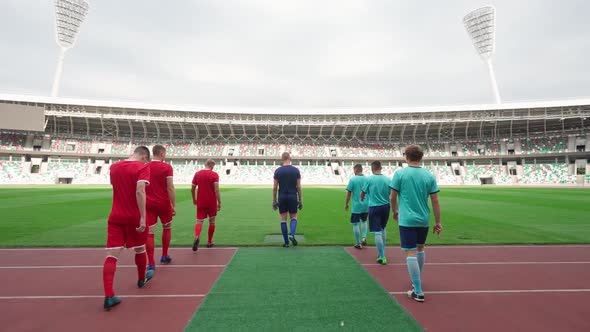 Pro Football Players Walks to the Stadium Rival Football Teams Walk Through the Stadium Back View