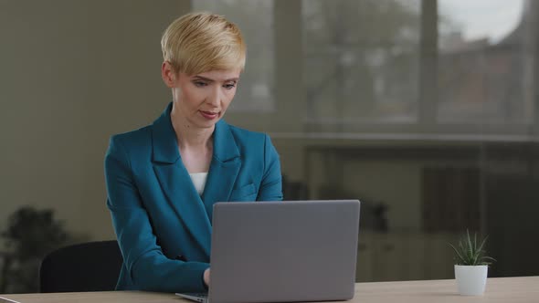 Adult 40s Business Woman Blonde with Short Hair Typing on Laptop Working in Internet Stylish Female