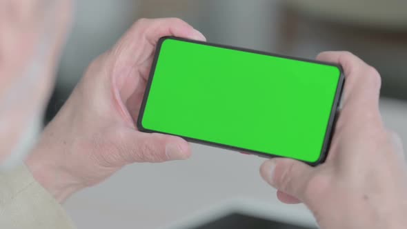 Close Up of Old Man Watching Smartphone with Chroma Screen