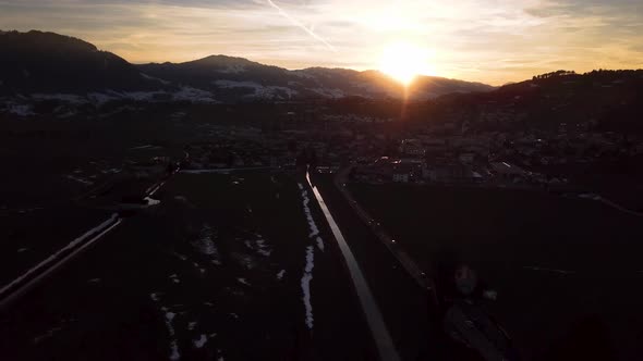 Sun flares through a mountain while winter in Switzerland.