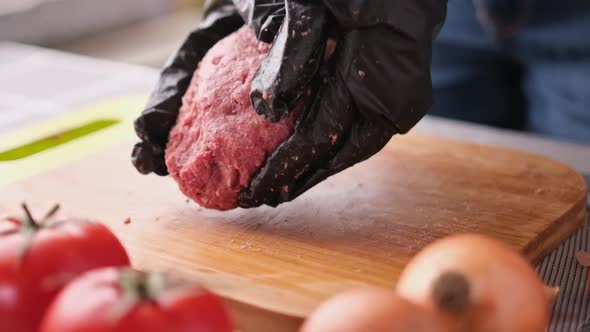 Woman Beats Minced Meat for Cooking Cutlets on Wooden Cutting Board