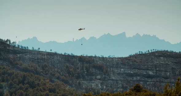 Helicopter Overflying the Wildfire Zone on Mountain in Spain Manresa