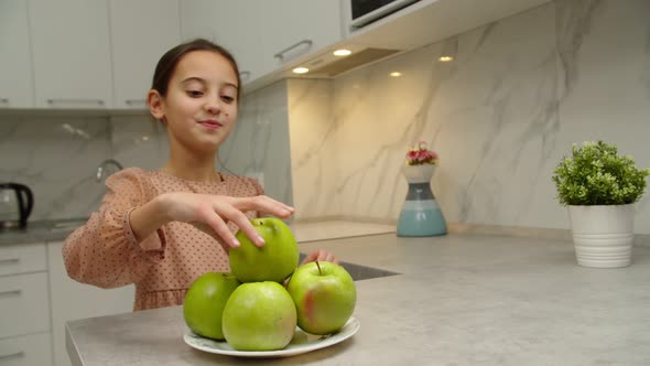 Preteen Girl Taking Fruit Biting Off Apple Smiling Charmingly Indoor