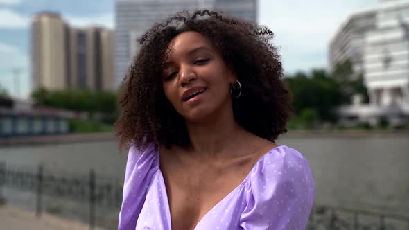 Portrait of a Happy African American Woman Dancing on a City Street Mixed Race Model with Afro Hair