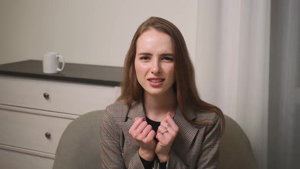 Excited Young Woman Feel Happy Sit on Couch Woman Celebrate Victory Success Woman Has Good News at