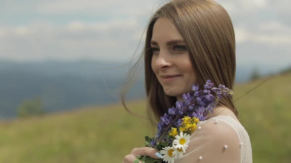 Close Up Shot of Brides Face. Bride in Wedding Dress Stay with Bouquet