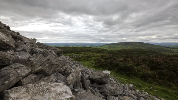 Time lapse of rural and remote landscape of grass, trees and rocks during the day in hills of Carrow alt