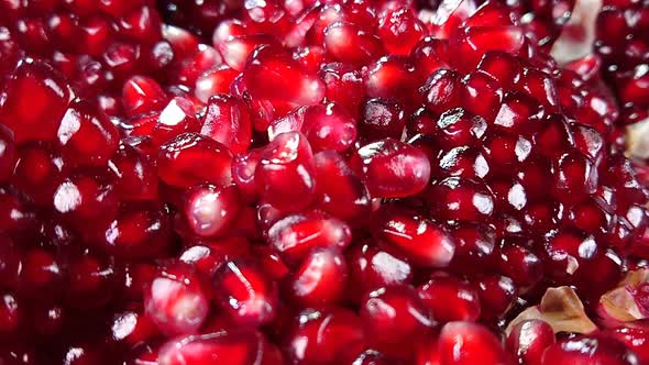 Fresh Pomegranate Grain Is Falling Down on a Pile