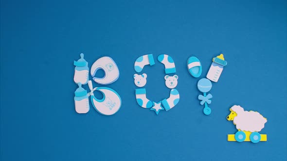 Funny Blue Stickers Symbolizing a Newborn Boy Appear on a Blue Background