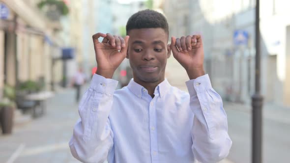 African Man Dancing in Celebration While Standing in Street