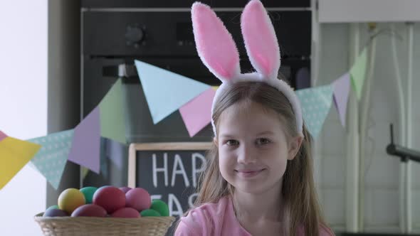 Portrait of Funny Easter Kid Wearing Bunny Ears in Decorated Kitchen