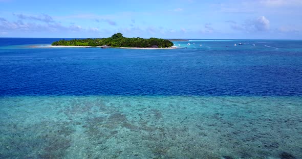 Wide angle birds eye abstract shot of a sunshine white sandy paradise beach and aqua blue water background