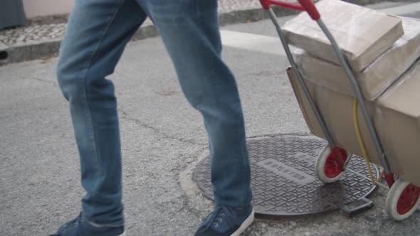 Deliveryman Wheeling Cart with Parcels