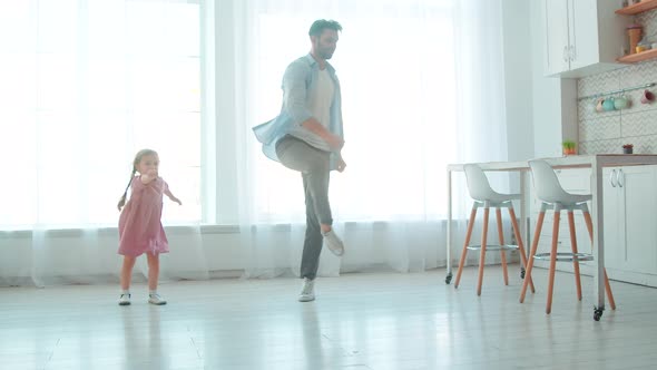 Dad and daughter spending time together at home. Lifestyle slow motion concept