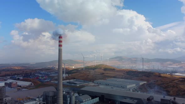 Aerial View of Pollution of the Environment a Pipe with Smoke and Wind Turbines