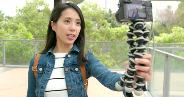 Young Woman taking video for vlog and walking in the street