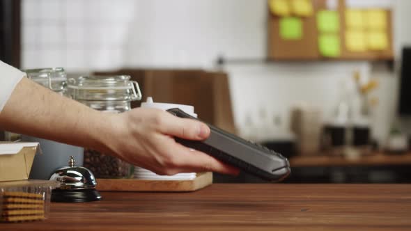 Paying with Smartphone Closeup Using NFC Technology in a Restaurant