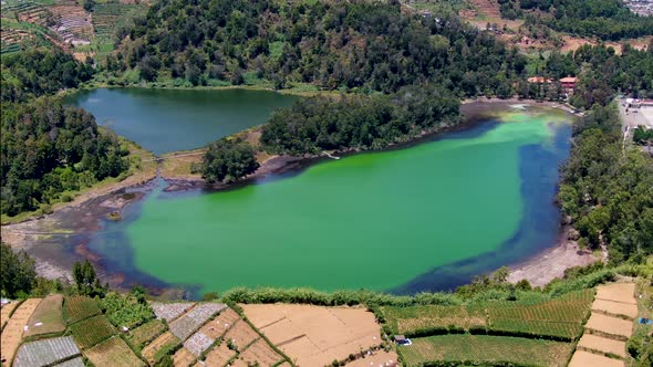 Beautiful green color Lake Warna at Dieng Plateau Java, Indonesia. aerial