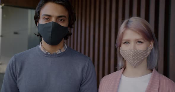 Slow Motion Portrait of Middle Eastern Guy and Caucasian Girl Wearing Face Masks Indoors