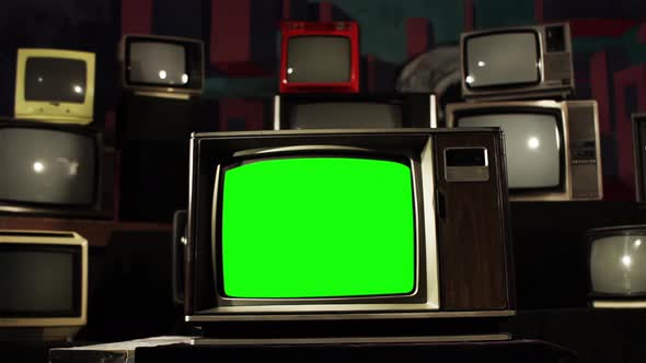 Vintage Television with Green Screen Among Many Retro TVs. Dolly Out. 4K Version.