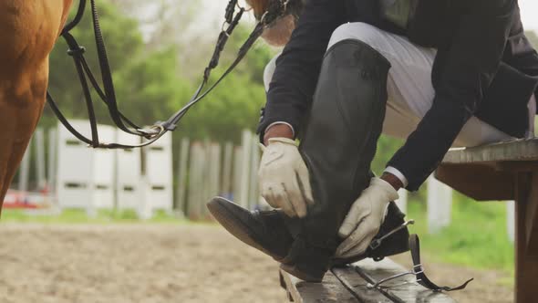 African American man preparing to ride a Dressage horse