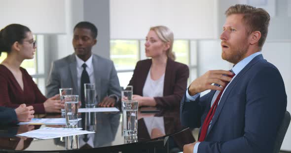 Nervous Young Businessman at Corporate Meeting Feeling Unwell