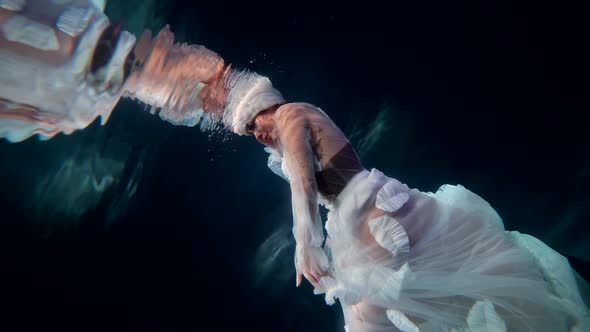 Amazing Undersea Fairy is Floating in Depth Under Water Surface of Lake Magical Ocean