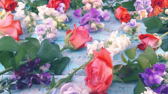 dragon flowers, roses, sweet pea on the vintage wooden light blue background