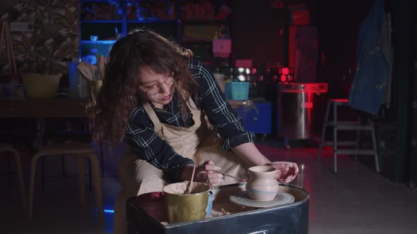 Pottery Crafting  Woman with Curly Hair Applying Blue and Red Colors on the Fresh New Pot