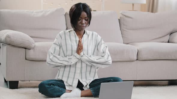 Young Concentrated Woman Sitting in Lotus Position with Closed Eyes on Floor in Room Attractive Calm