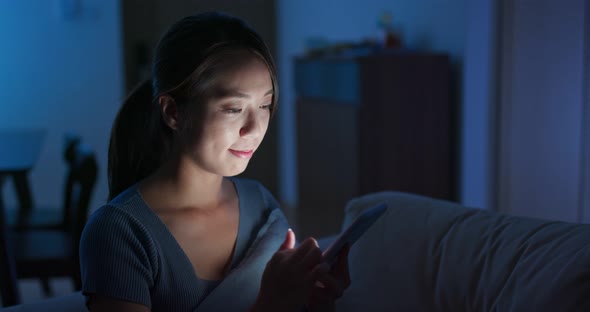 Woman look at  mobile phone at night