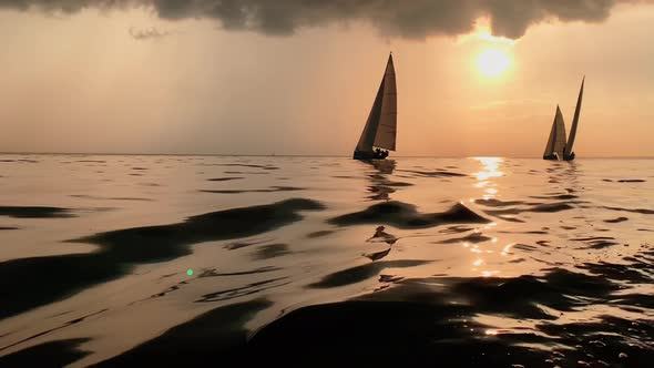 A Few Sailboats in a Sea at Sunset Magic Sun Reflection Sun Path the Sky of Pink Color the Darkness