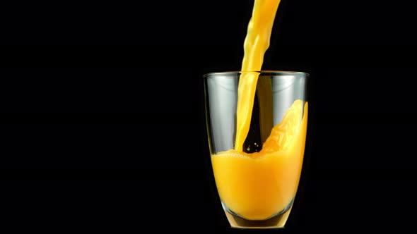 Super Slow Motion Shot of Pouring Fresh Orange Juice Into Glass at 1000 Fps
