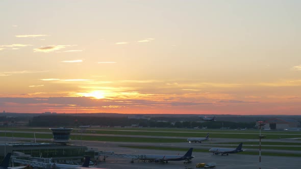 View of Airport at Sunset, Plane Taking Off