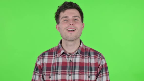 Portrait of Young Man Shaking Head As Yes Sign Green Chroma Screen